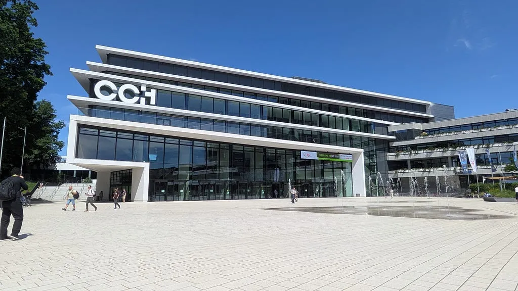 Modern glass facade of Congress Center Hamburg beneath a blue sky